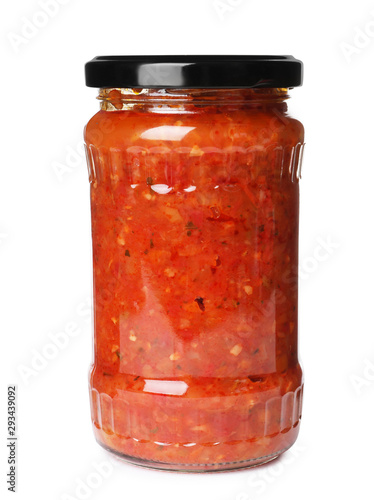 Glass jar with pickled red sauce isolated on white