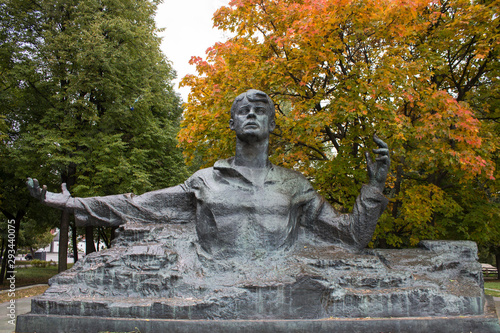 monument to Sergei Yesenin against a bright autumn tree in Ryazan Russia