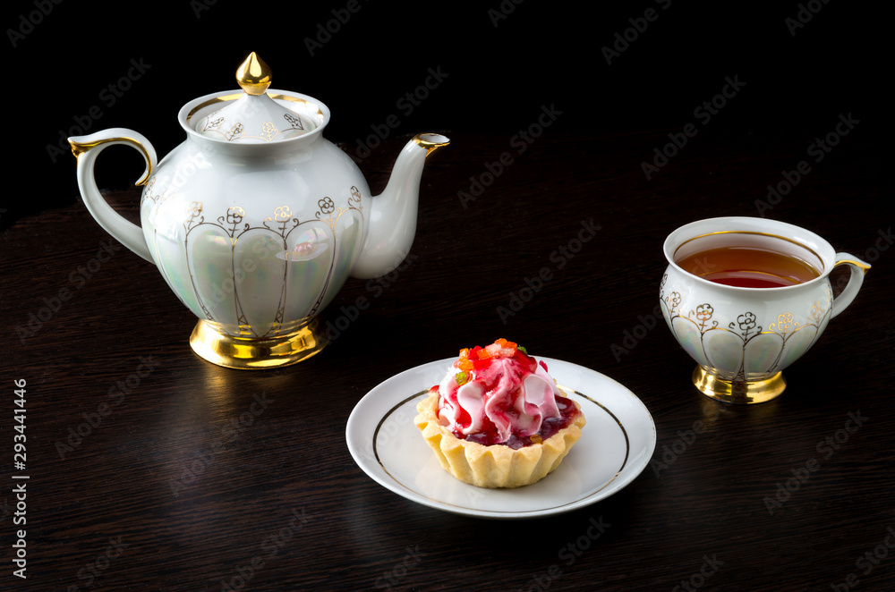 Basket-cake with jam and tea set on dark background Basket-cake with jam and tea set on dark background