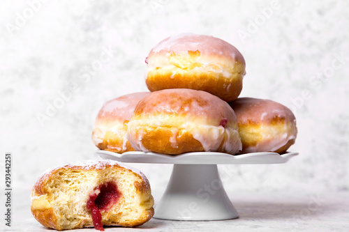 Traditional Polish donuts with frostng on light background. Tasty doughnuts with jam.