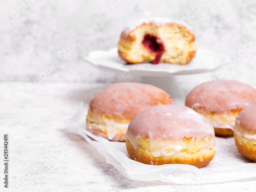 Traditional Polish donuts with frostng on light background Fototapeta