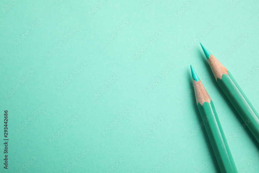 Flat lay composition with color pencils on turquoise background. Space for text Flat lay composition with color pencils on turquoise background. Space for text