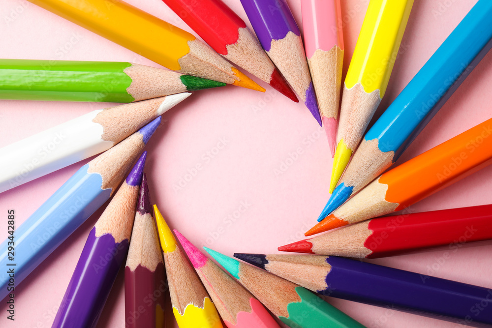 Fototapeta premium Frame made of color pencils on pink background, flat lay. Space for text