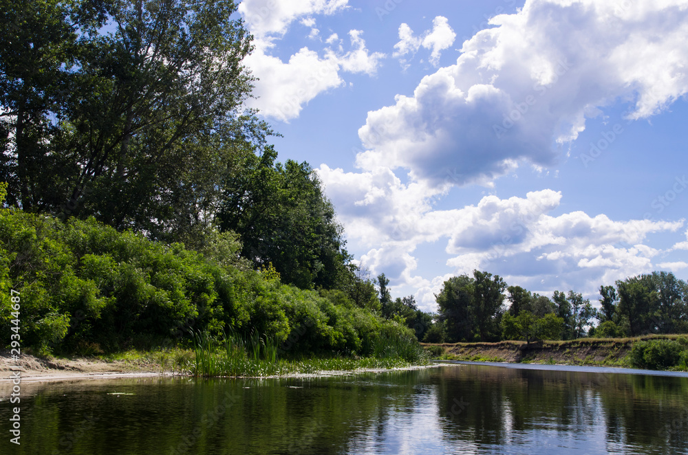 Quiet river with deciduous trees on the banks Quiet river with deciduous trees on the banks