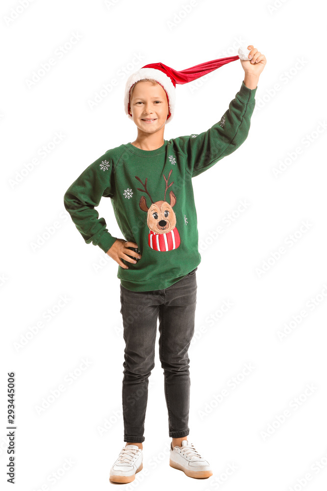 Little boy in Christmas sweater and Santa hat on white background Little boy in Christmas sweater and Santa hat on white background