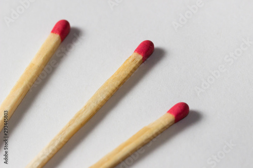 three diagonal matchsticks together on white background