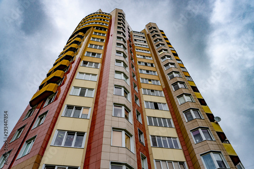 the wall of a high-rise apartment building against the sky