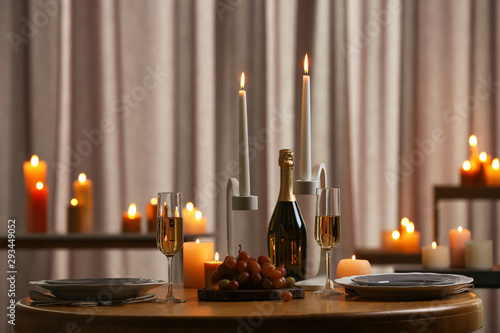 Festive table setting with burning candles indoors photo