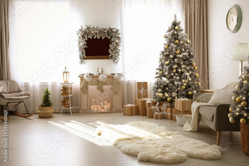 Stylish Christmas interior with beautiful decorated tree and fireplace