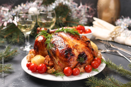Baked chicken with honey, soy sauce, onion and garlic, served with potatoes and cherry tomatoes, Christmas background, horizontal orientation, closeup