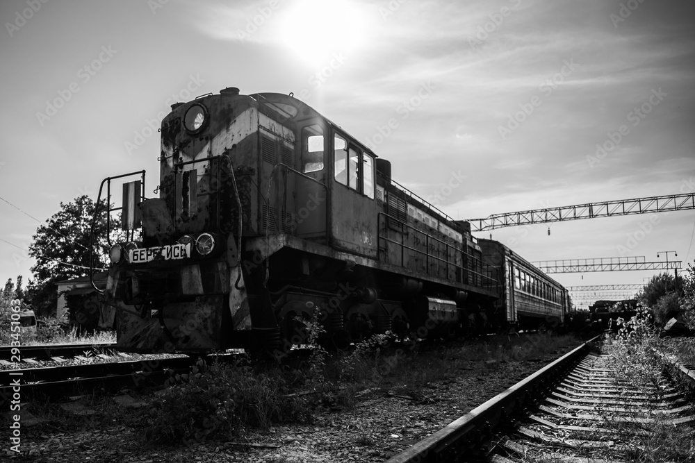 Black and white rusty train on abanxdoned railway line