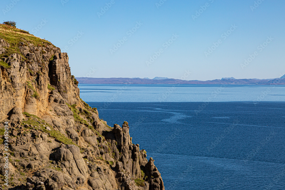 Looking out over the ocean from the Isle of Skye with rugged rock formations in the foreground