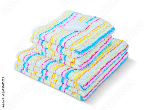 Obraz na płótnie Stack of colorful towels with one soap isolated on a white background. w salonie