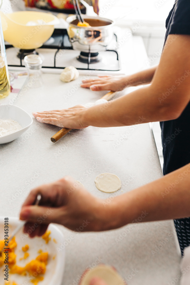 Close up hands while doing roll out doughs for patty,pastry and raviaoli Close up hands while doing roll out doughs for patty,pastry and raviaoli