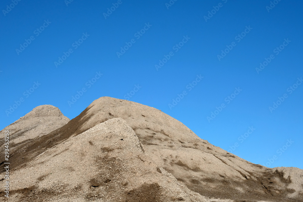 Mountain of grit with a blue sky background