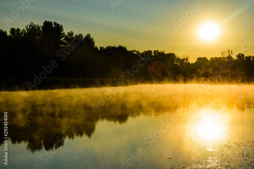 Fog above the water surface. Sunrise at river