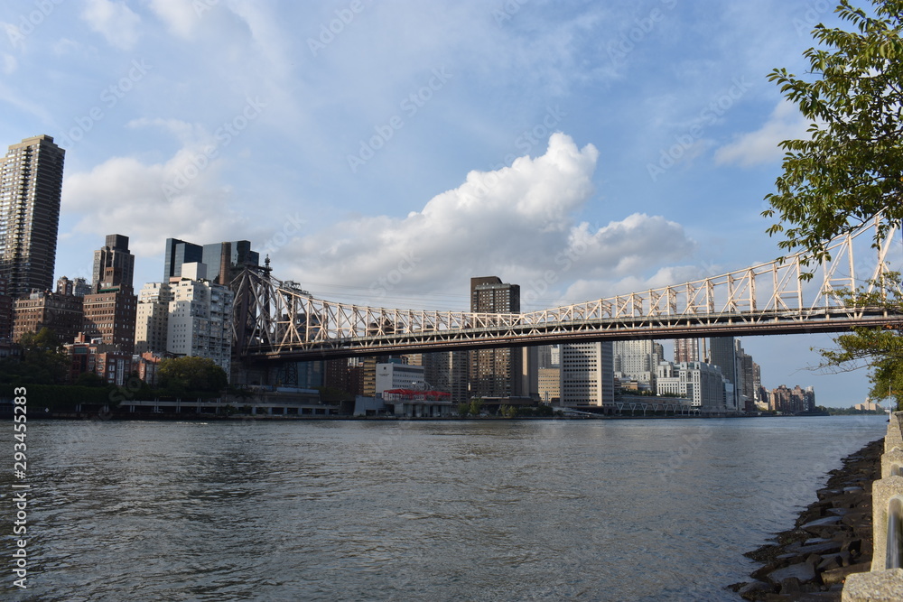 The Ed Koch Queensboro Bridge, also known as the 59th Street Bridge, and the midtown Manhattan skyline viewed from New York City's Roosevelt Island. -08