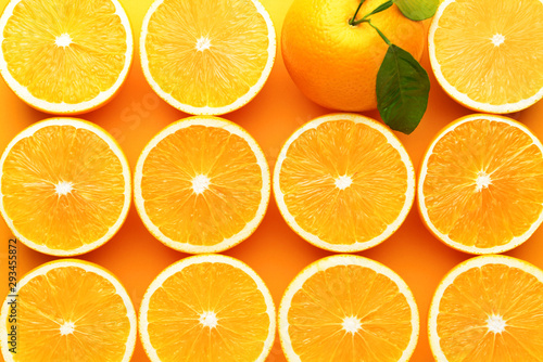Whole orange among cut ones on color background. Concept of uniqueness