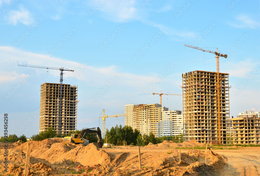Fototapeta premium Tower cranes at construction site, construction of high-rise building - Image