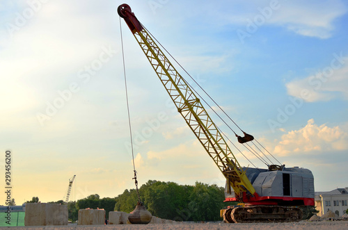 Fotografie Large crawler crane or dragline excavator with a heavy metal wrecking ball on a steel cable