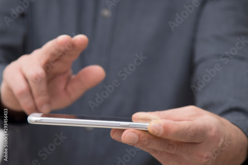 businessman hands with mobile touch phone, closeup view