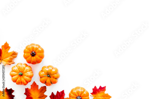 Autumn background with leaves and pumpkins on white top view copy space frame