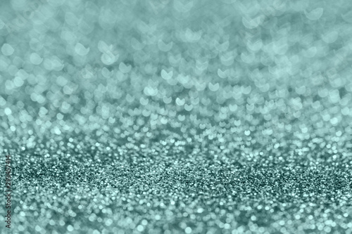 Abstract composition. Pale silver blue glitter light background with beautiful bokeh, selective focus, shallow depth of field