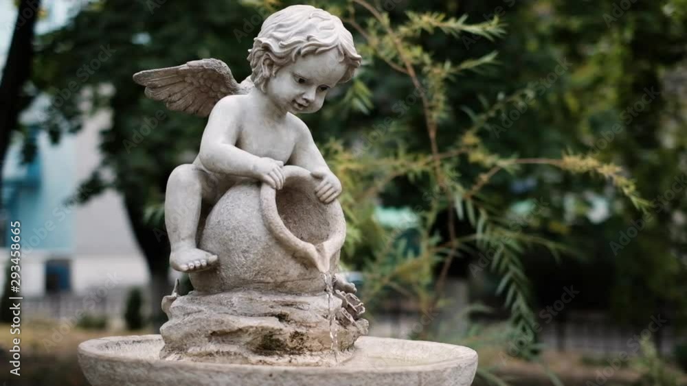 Little angel cupid boy fountain pours water Little angel cupid boy fountain pours water
