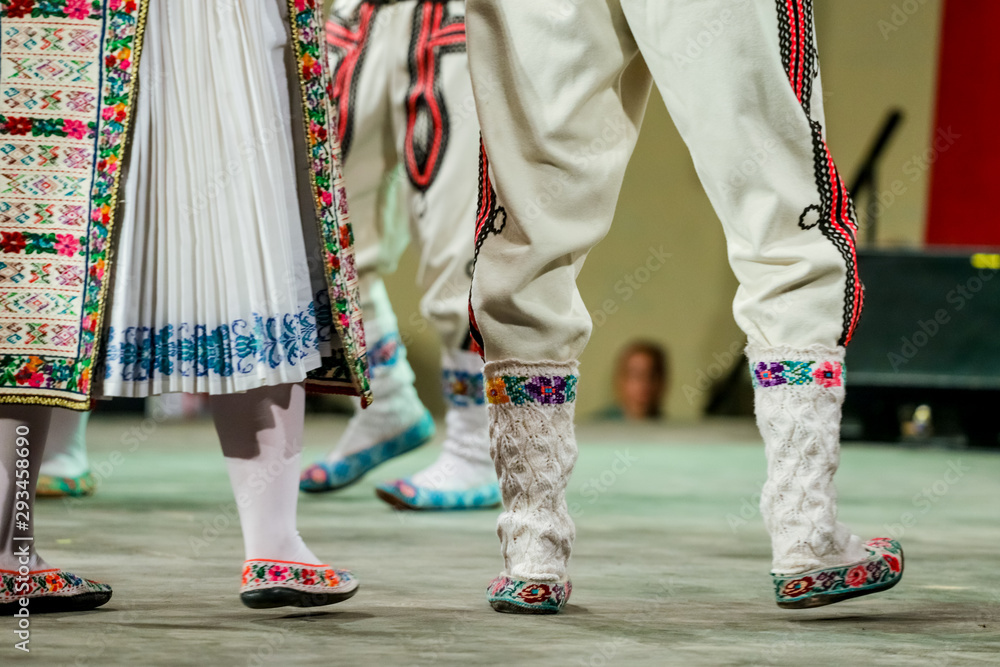 Close up of wool socks on legs of young Romanian dancer in traditional folkloric costume. Folklore of Romania Close up of wool socks on legs of young Romanian dancer in traditional folkloric costume. Folklore of Romania