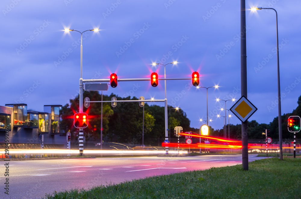 Slow shutter speed night photo of Dutch traffic lights with red brake