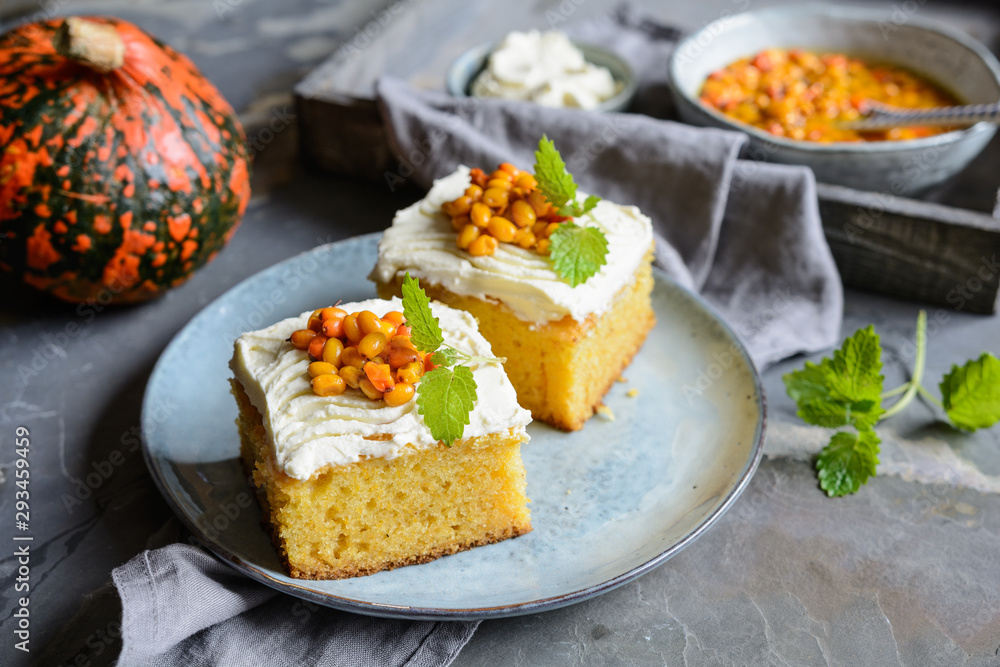 Slices of pumpkin cake topped with cream cheese  and Sea Buckthorn compote