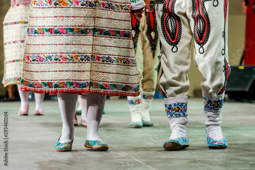 Close up of wool socks on legs of young Romanian female and male dancers in traditional folkloric costume. Folklore of Romania