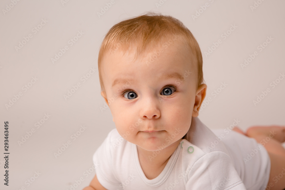 cute toddler boy on white background looking in frame, space for text, baby 8 months on white background