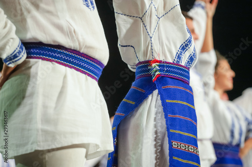 Close up on detail of young Romanian female dancer traditional folkloric costume. Folklore of Romania