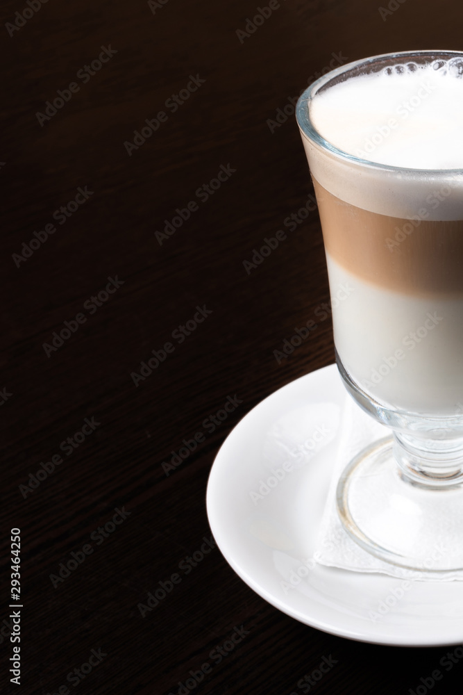 Mug of latte, on a dark, wooden background. Mug of latte, on a dark, wooden background.