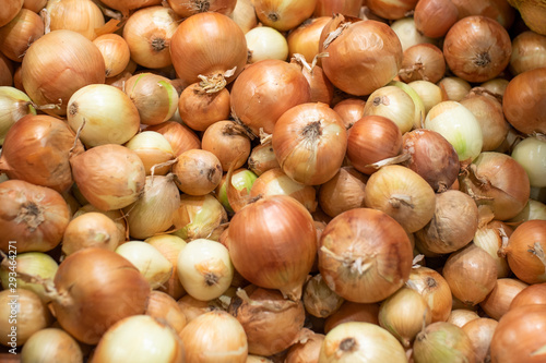 Onions at the a supermarket counter. Background.