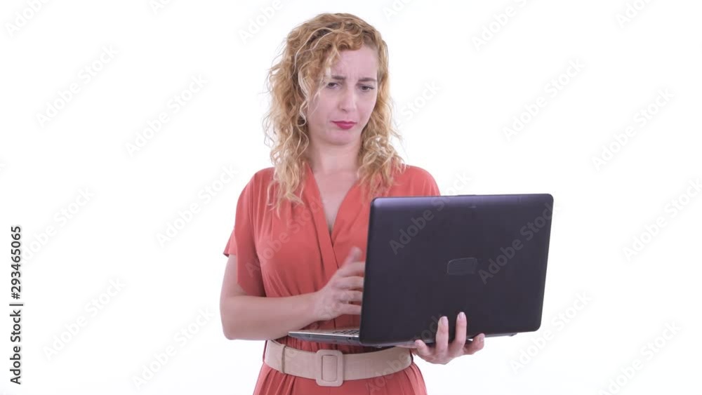 Happy beautiful blonde businesswoman talking while using laptop Happy beautiful blonde businesswoman talking while using laptop