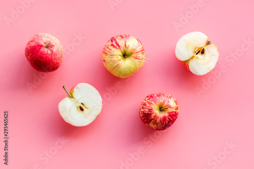 Red apples pattern on pink background top view