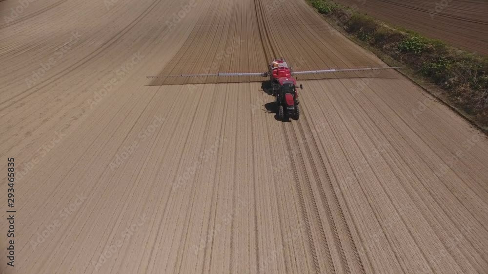 Aerial view of agricultural machinery treated field with chemicals. Aerial view of agricultural machinery treated field with chemicals.
