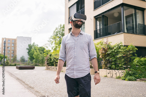 Man wearing Virtual Reality Glasses outdoors photo