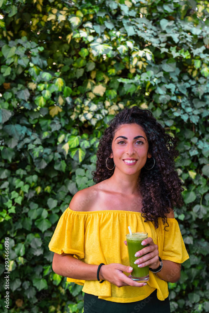Portrait of smiling young woman holding a healthy drink Portrait of smiling young woman holding a healthy drink