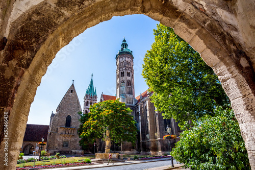Low angle view of Naumburger Dom and trees against sky seen from archway