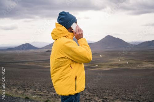 Mature man talking on his smartphone in the Icelandic highlands