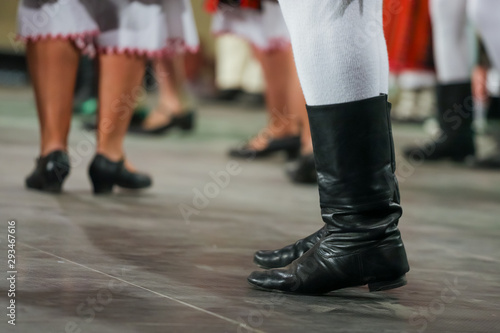 Close up of legs of young Romanian male dancer in traditional folkloric costume. Folklore of Romania