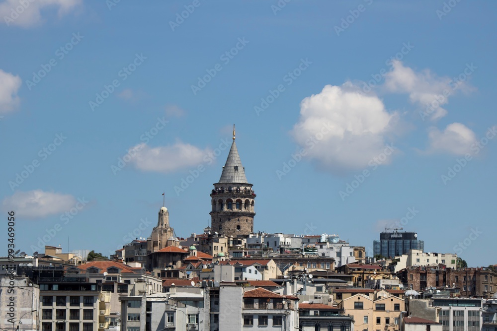 Close shot of Galata tower. Flying seagulls and blue sky.
