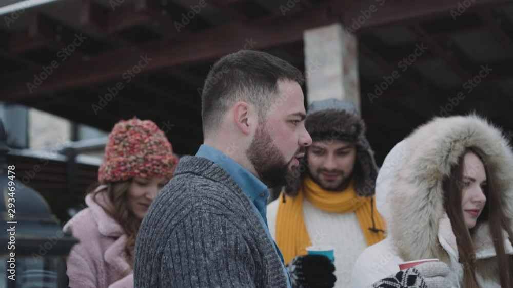 Friend company drinks hot beverage on cold, winter street Friend company drinks hot beverage on cold, winter street