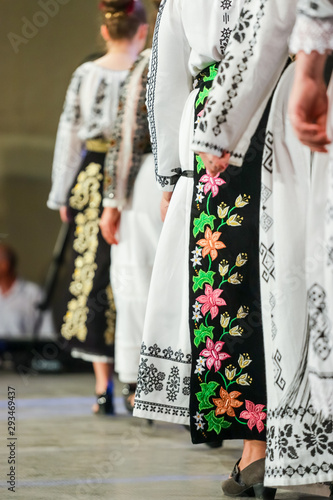 Close up on detail of young Romanian female dancer traditional folkloric costume. Folklore of Romania