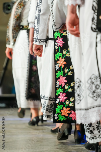 Close up on detail of young Romanian female dancer traditional folkloric costume. Folklore of Romania