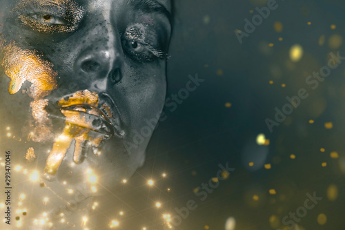 Gold Paint smudges drips from woman face, lips and hand, lipgloss dripping from sexy lips, golden liquid drops on beautiful model girl's mouth, gold metallic skin make-up