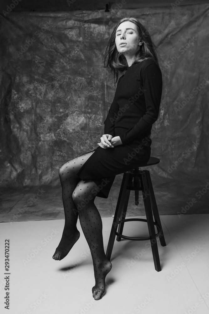 Fototapeta premium Beautiful feminine girl in a dress on a canvas background. Art portrait